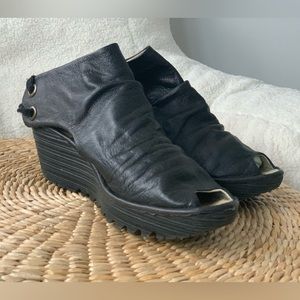 Fly London black leather shoes. Tie up at back